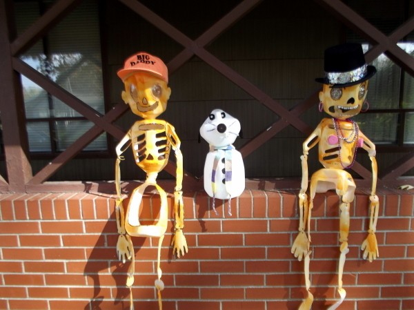 Decorations sitting on patio wall.