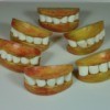 Halloween treat made with apple slices and marshmallows made to look like lips and teeth.