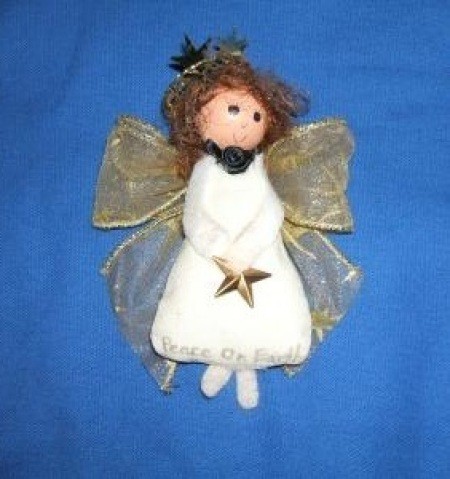 Cute white kitchen angel with gold ribbon wings.