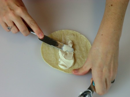 spread cream cheese on tortilla