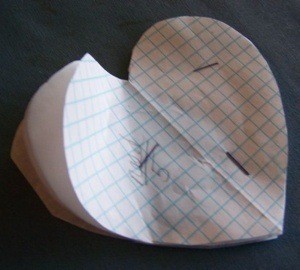 Paper heart shape stapled together.