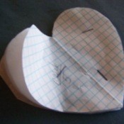 Paper heart shape stapled together.