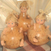 Gourds with baby dolls inside simulating a baby popping out of the gourd.