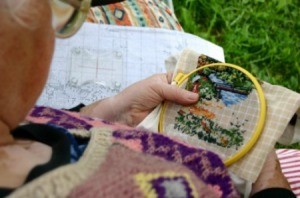 A woman doing cross stitch.