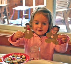 Child holding the finished gingerbread people.
