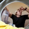 Stinky Laundry In Washing Machine with Man Holding Nose