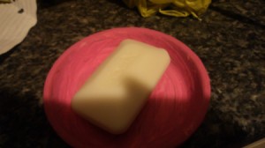 Bar of soap in clay saucer.