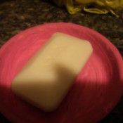 Bar of soap in clay saucer.