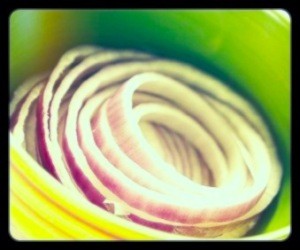 Slices of red onion in bowl.