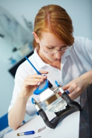 A dental technician working on new dentures.