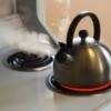 A tea kettle on a stovetop.
