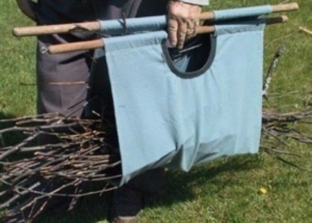 Tote being used to carry twigs.