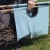 Tote being used to carry twigs.