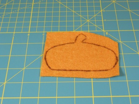 Tracing of acorn cap on felt square.