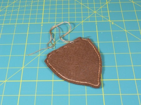 Sewing outline stitch on acorn.