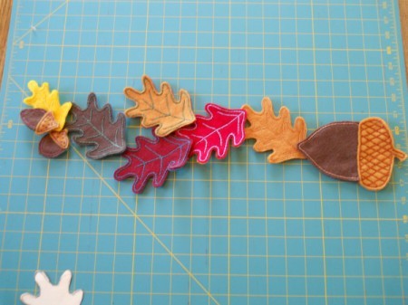 Creating pleasing arrangement of leaves and acorns.