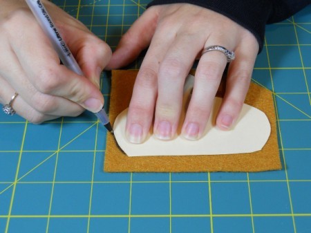 Tracing acorn cap template onto felt.