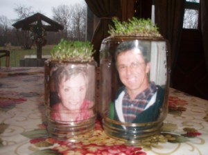 Chia spouting on bottoms up Mason jar, with photos inside.