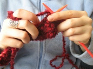 A woman holding yarn.