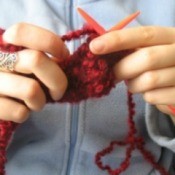 A woman holding yarn.