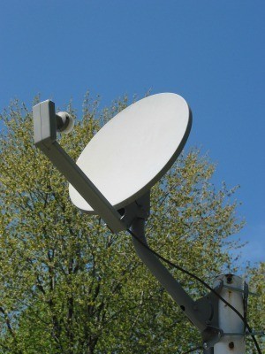 A DIRECTV style dish on a rooftop.