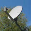 A DIRECTV style dish on a rooftop.