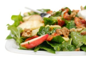 A healthy salad with light dressing on it.