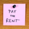 Sticky note reminder to pay the rent.