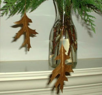 Leaves hanging from evergreen garland.