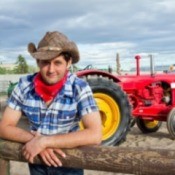 A photo of a cowboy on a farm.