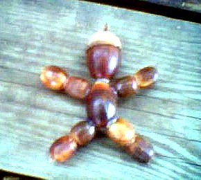 Man shaped decoration made from acorns.