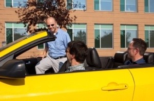 Man getting into a yellow car