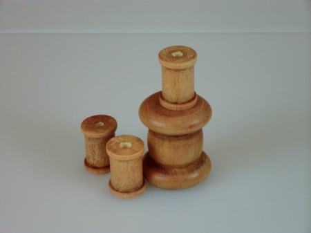 Stained wooden spools.