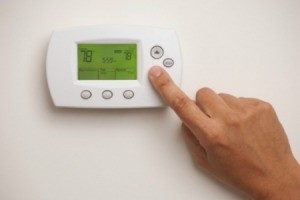 Adjusting a thermostat.