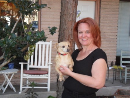 Woman holding small dog.
