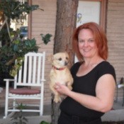 Woman holding small dog.
