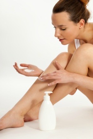 Woman Moisturizing Her Legs