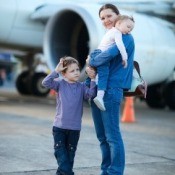 Mother Getting on Plane with Young Children