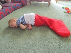 Child in large Christmas stocking.