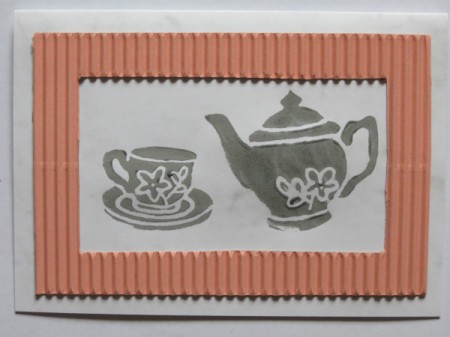 Stamped teapot and cup image.