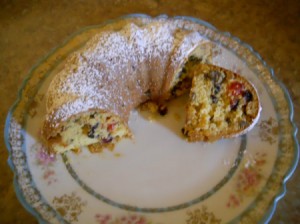 Cake on plate with one slice cut.