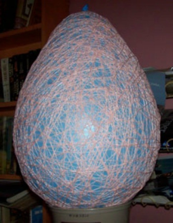 A balloon wrapped in yarn.