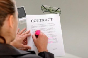 A woman signing a contract.