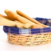A basket of long slender breadsticks.