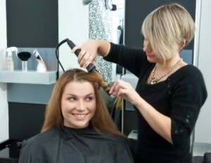 A woman getting her hair done.