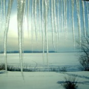 Snowy fields, frozen lake, and and icicles.