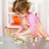 A toddler making cookies.