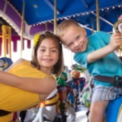 Two kids at an amusement park.