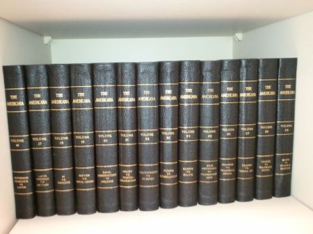 Blue bound encyclopedias on a shelf.