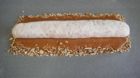 Adding marshmallow role to center of caramel.